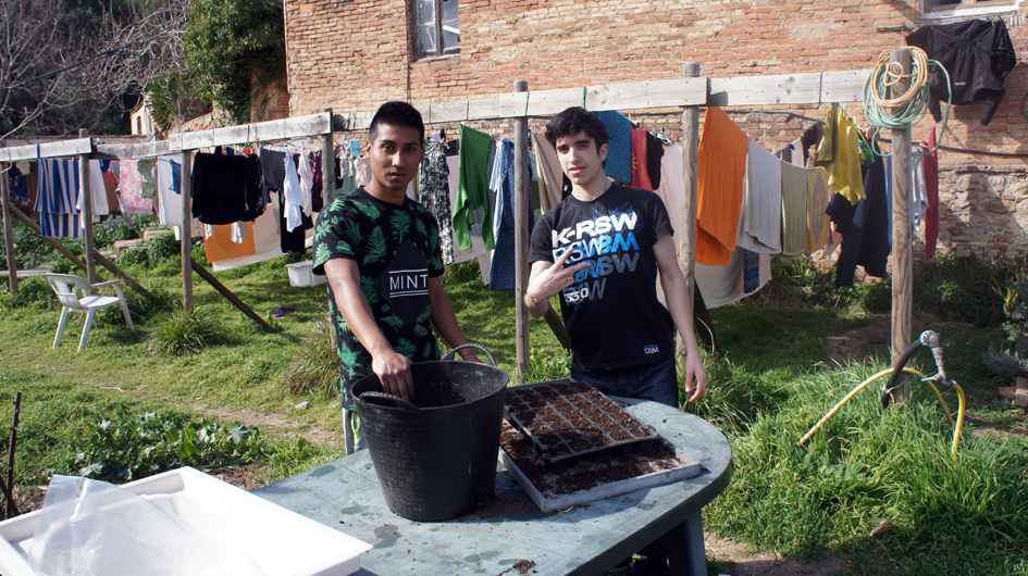 los 2 adolescentes llenaron los contenedores de tierra y plantan las primeras semillas - les 2 adolescents qui ont rempli les bacs de terre et planté les premières graines.